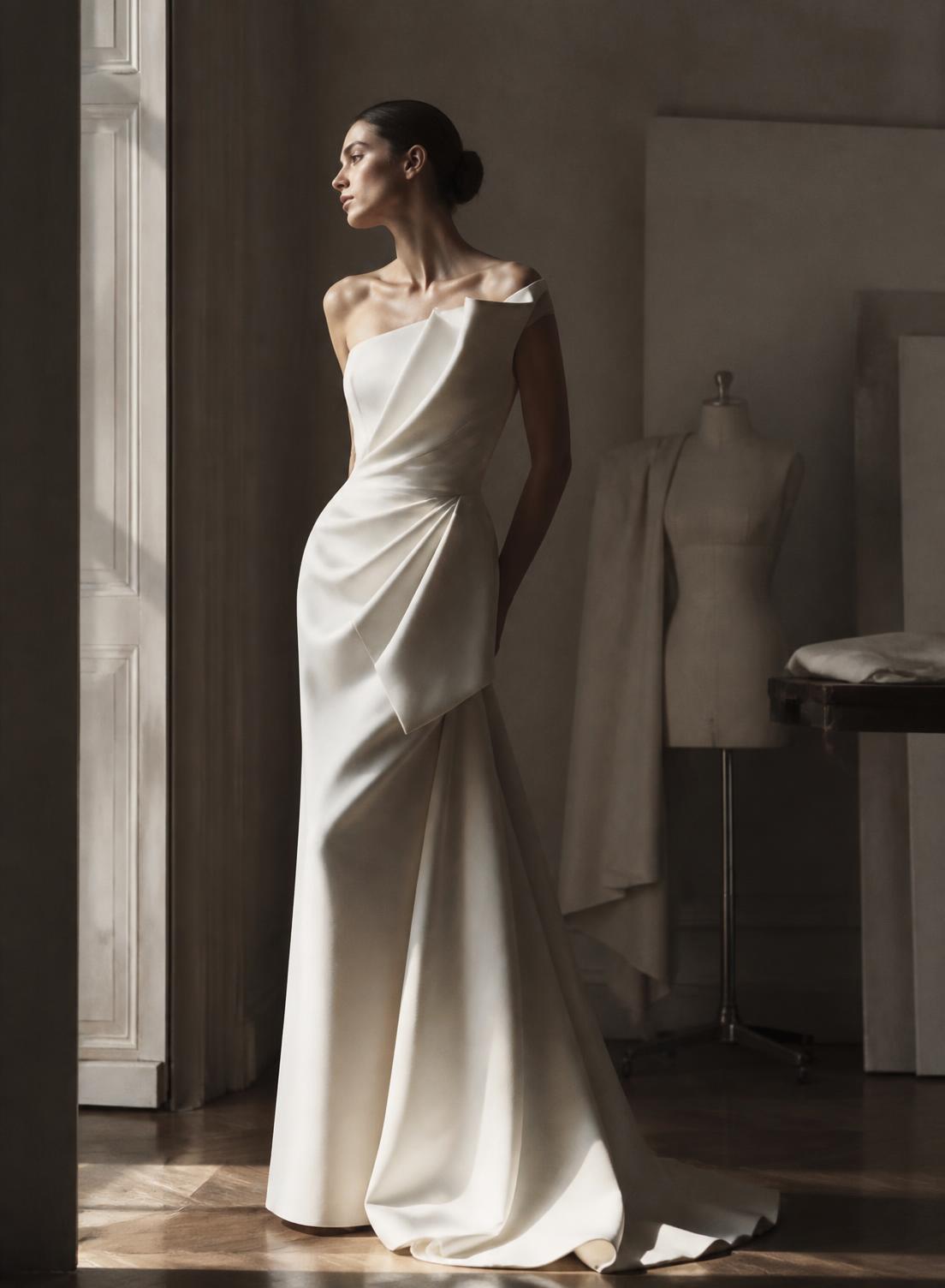 Model wearing a sculptural ivory bespoke gown